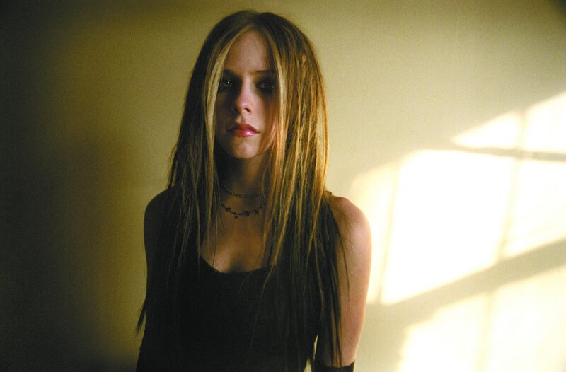 Avril Lavigne in a dimly lit room