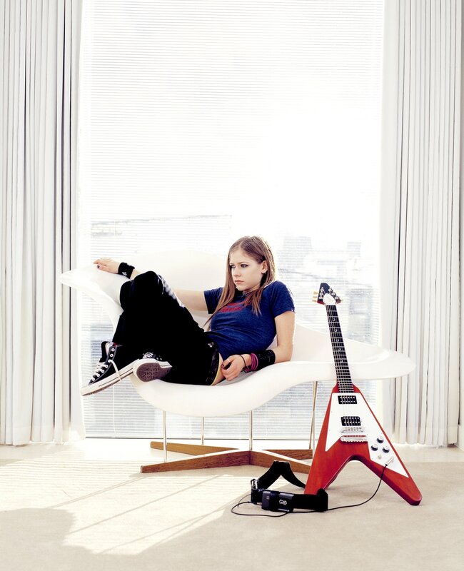 Avril Lavigne in a modern chair