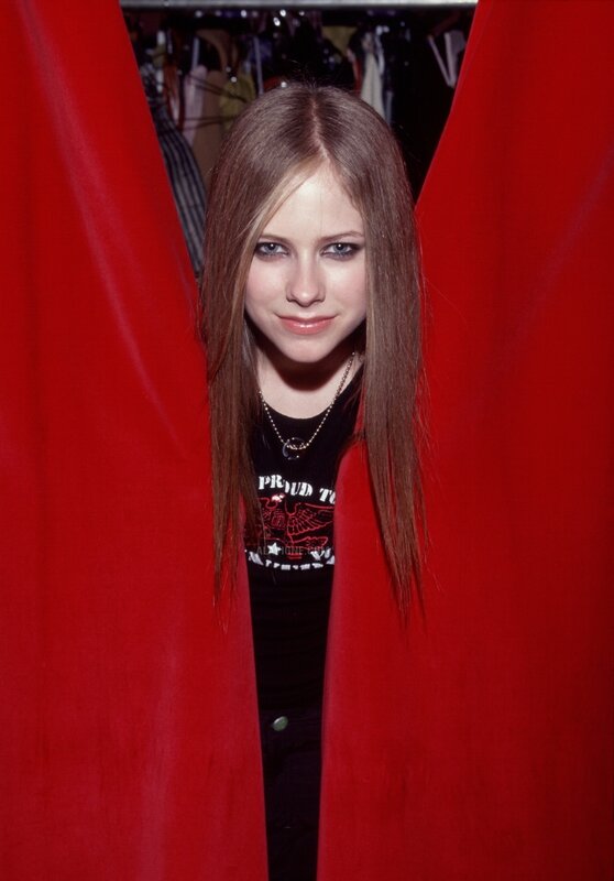 Avril Lavigne in red curtains