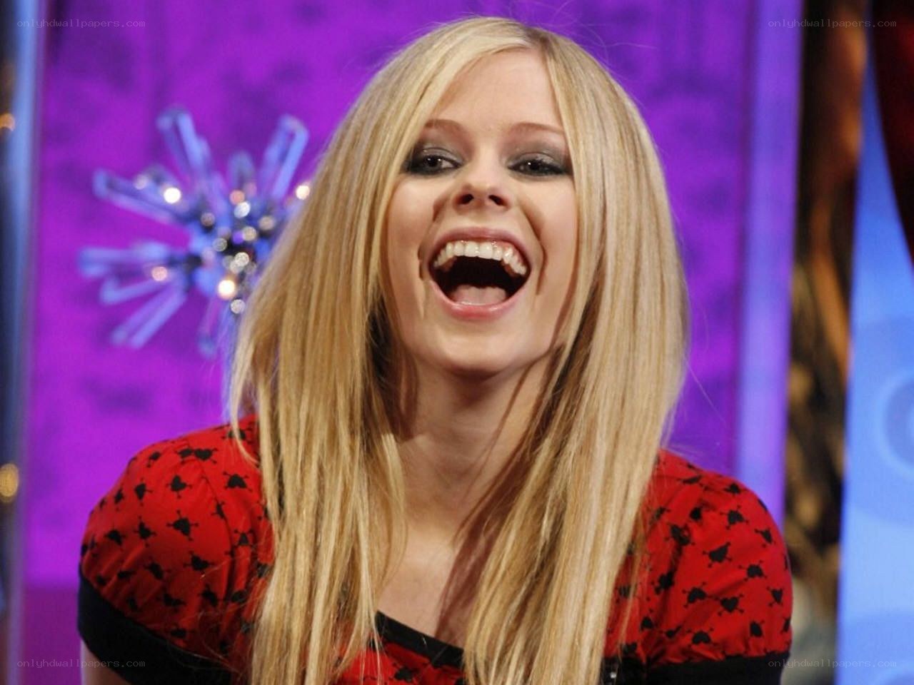 Avril Lavigne laughing on stage