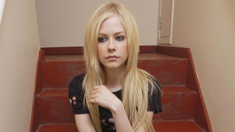 Avril Lavigne on red stairs