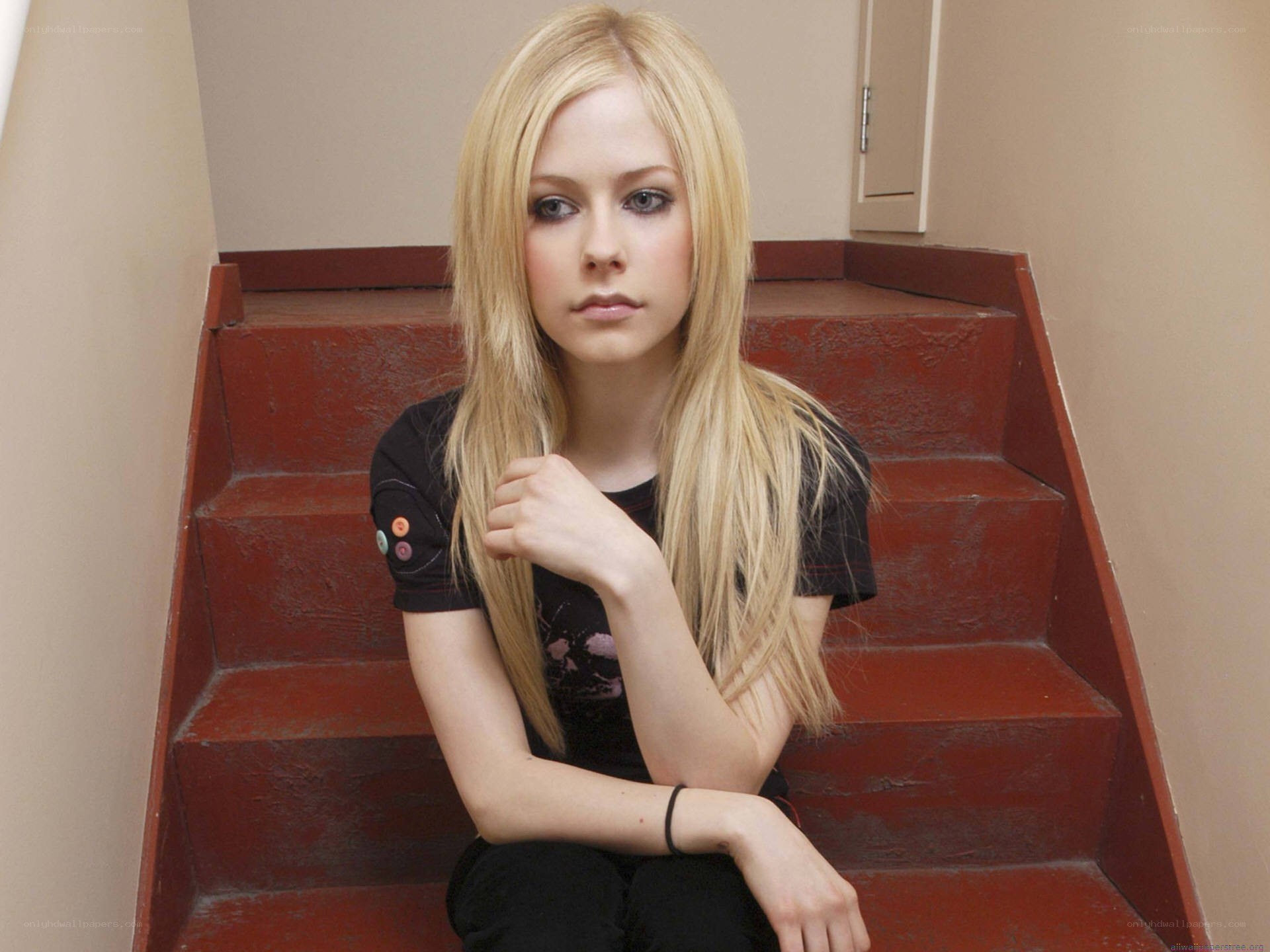 Avril Lavigne on red stairs