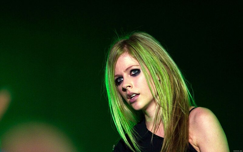 Avril Lavigne on stage with green lighting