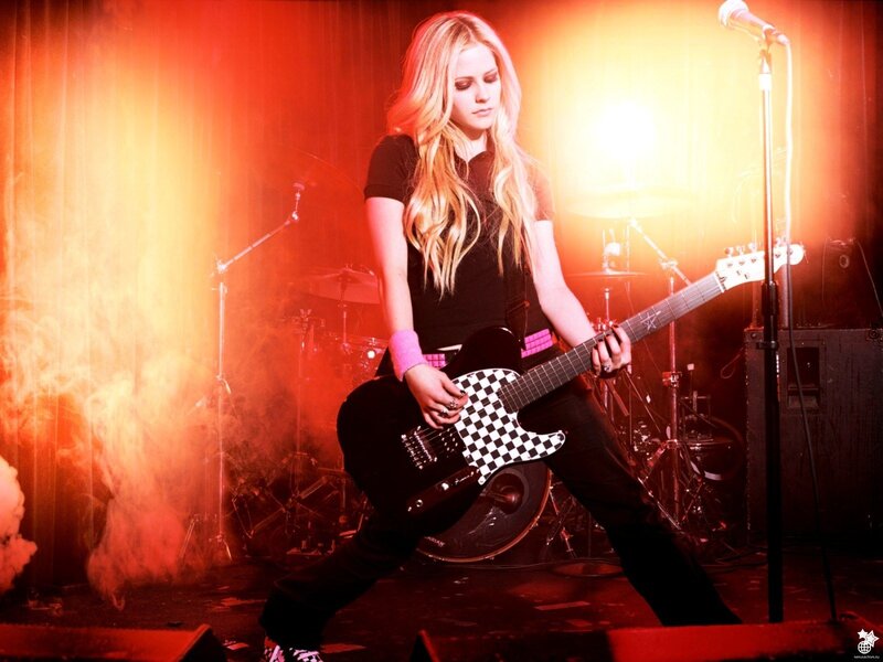 Avril Lavigne on stage with guitar