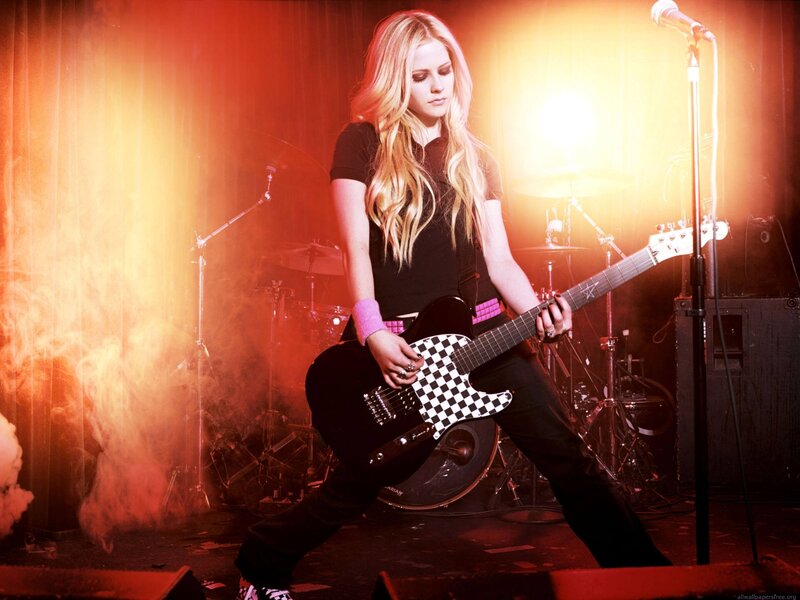 Avril Lavigne on stage with guitar