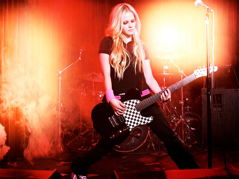 Avril Lavigne on stage with guitar