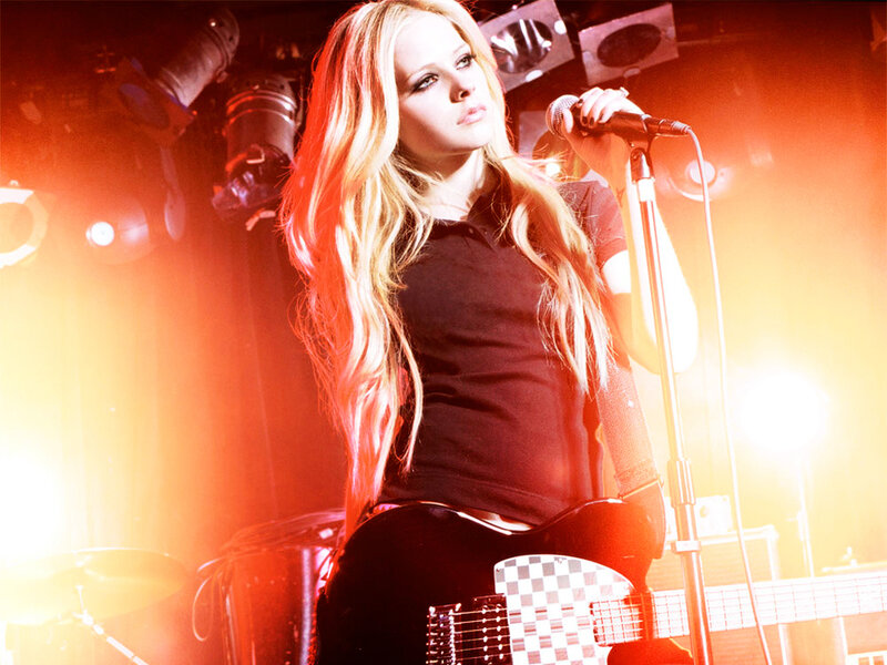 Avril Lavigne on stage with guitar
