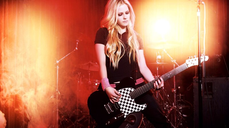Avril Lavigne on stage with guitar