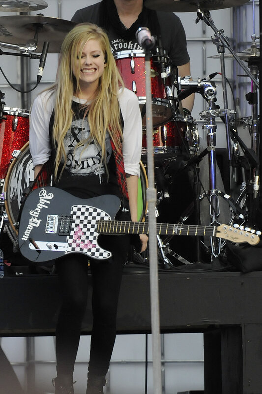 Avril Lavigne on stage with guitar