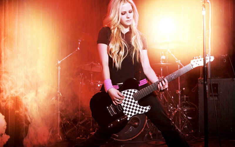 Avril Lavigne on stage with guitar