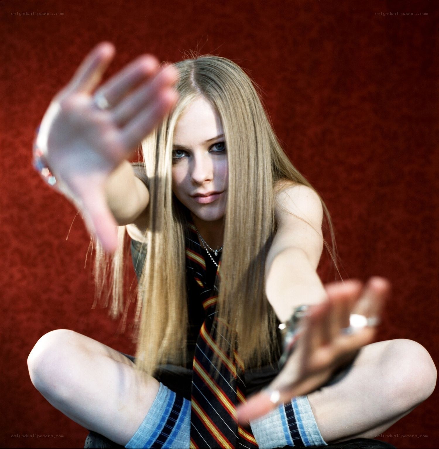 Avril Lavigne posing with hands forward
