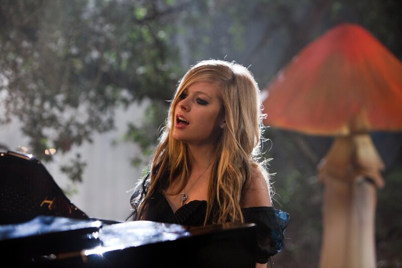 Avril Lavigne singing at piano