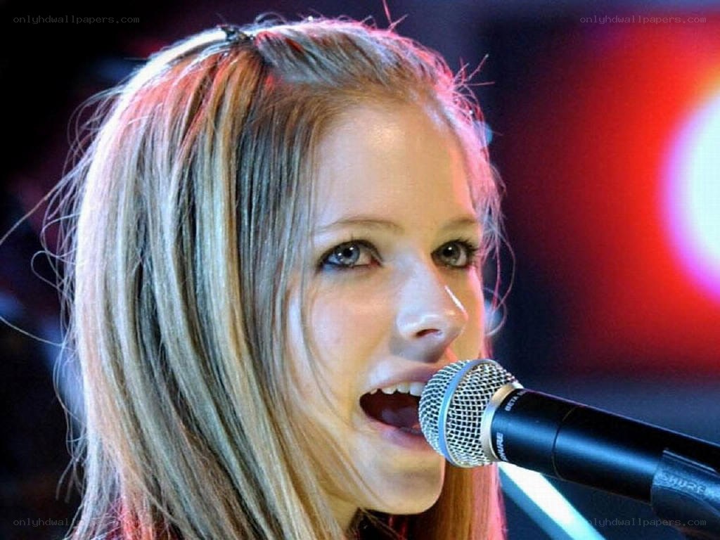 Avril Lavigne singing into microphone