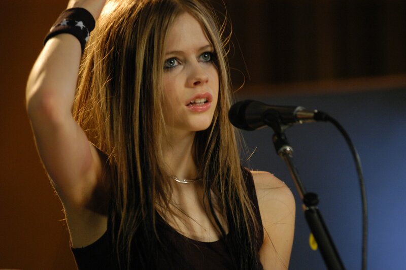 Avril Lavigne singing into microphone
