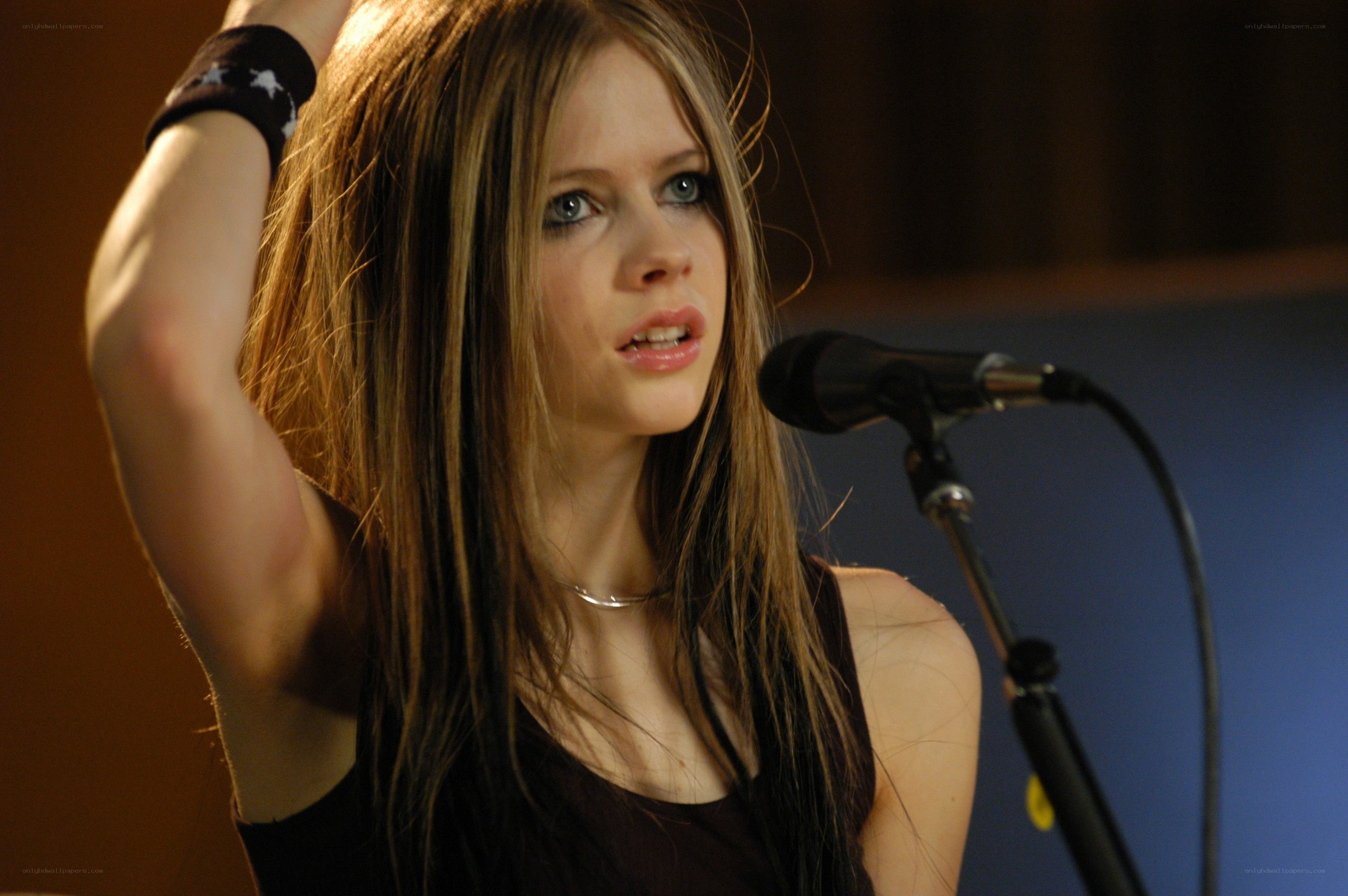 Avril Lavigne singing into microphone