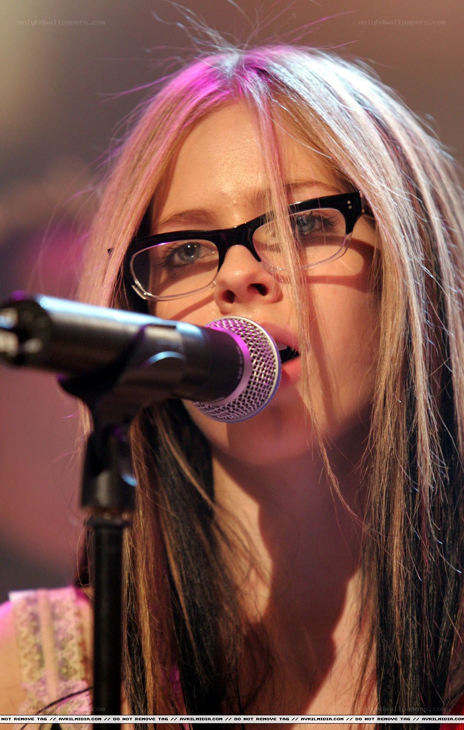 Avril Lavigne singing into microphone