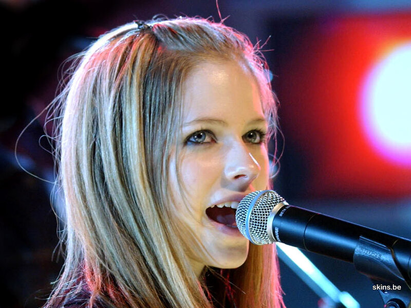 Avril Lavigne singing into microphone