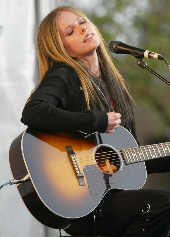 Avril Lavigne singing with guitar