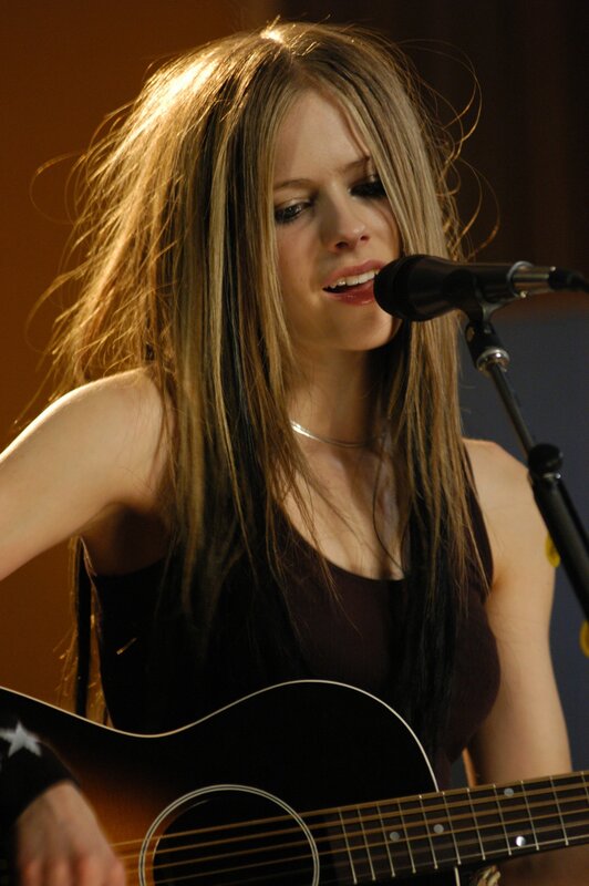 Avril Lavigne singing with guitar