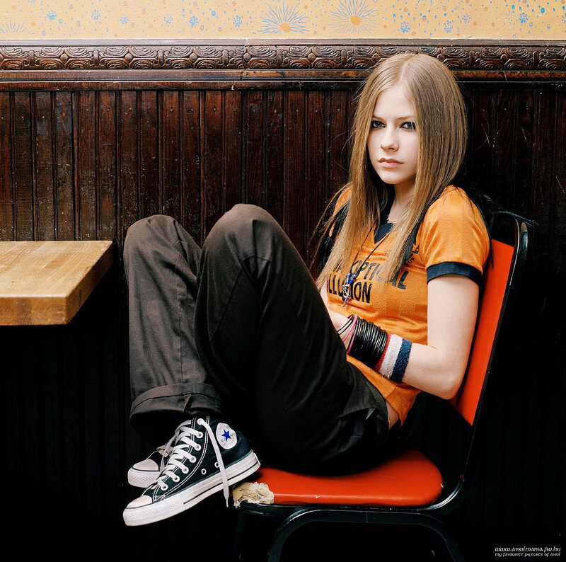 Avril Lavigne sitting in a booth