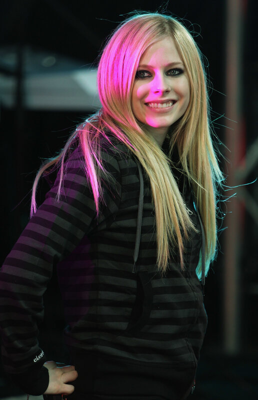 Avril Lavigne smiling on stage
