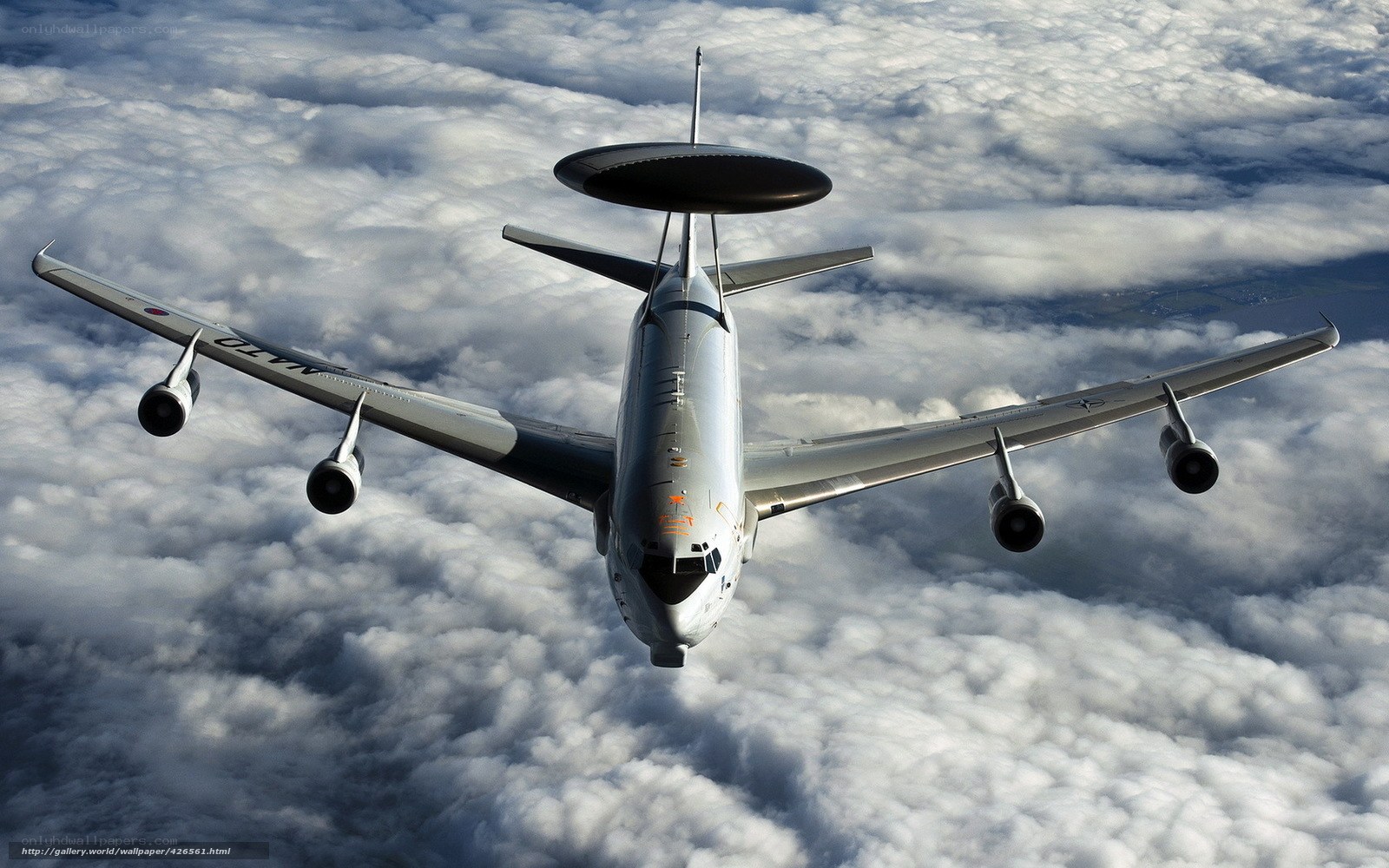 AWACS aircraft flying above clouds