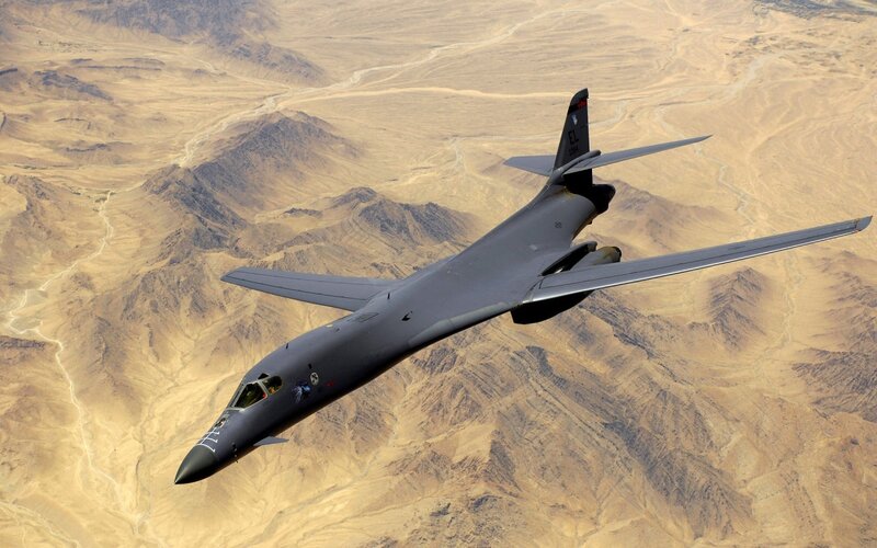 B-1 Lancer Bomber — Gray, Aerial, Afternoon, Photograph, Desert Landscape