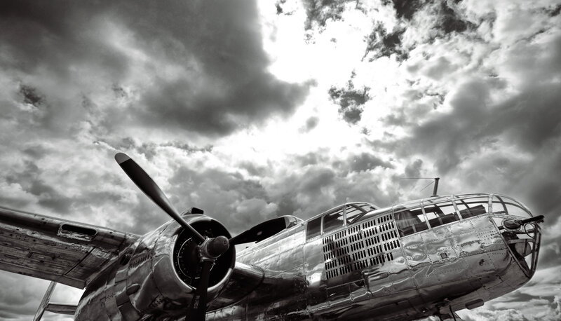 B-25 bomber under cloudy sky