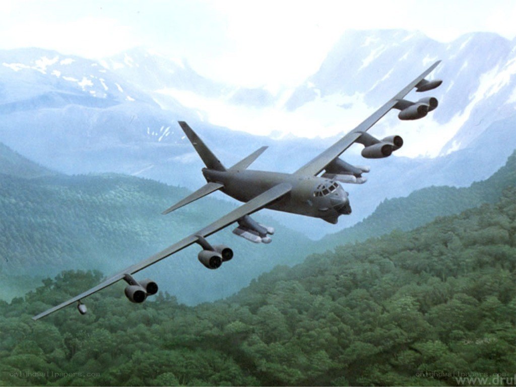 B-52 bomber flying over mountains