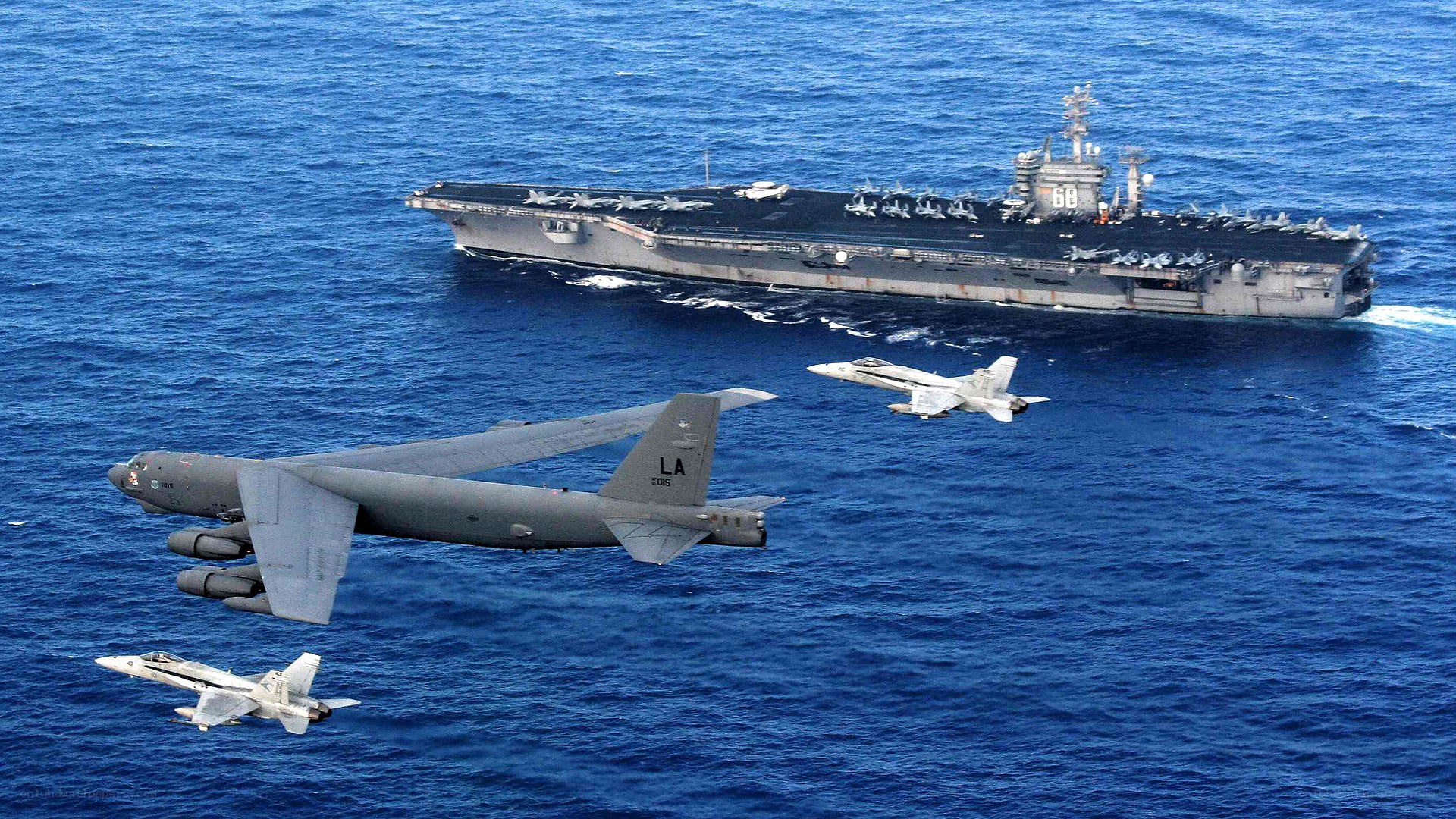 B-52 with fighter escorts over carrier