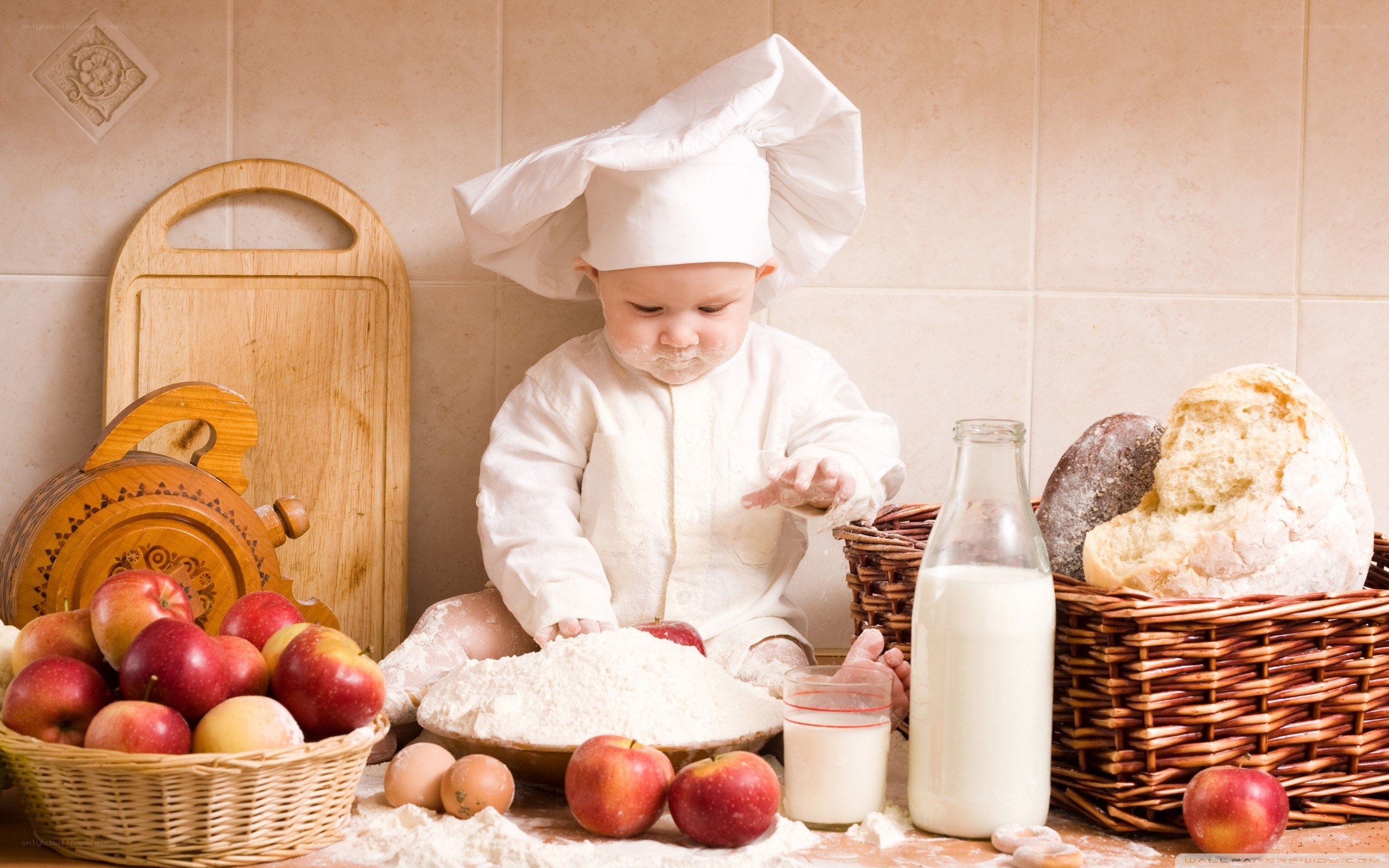 Baby chef playing with flour