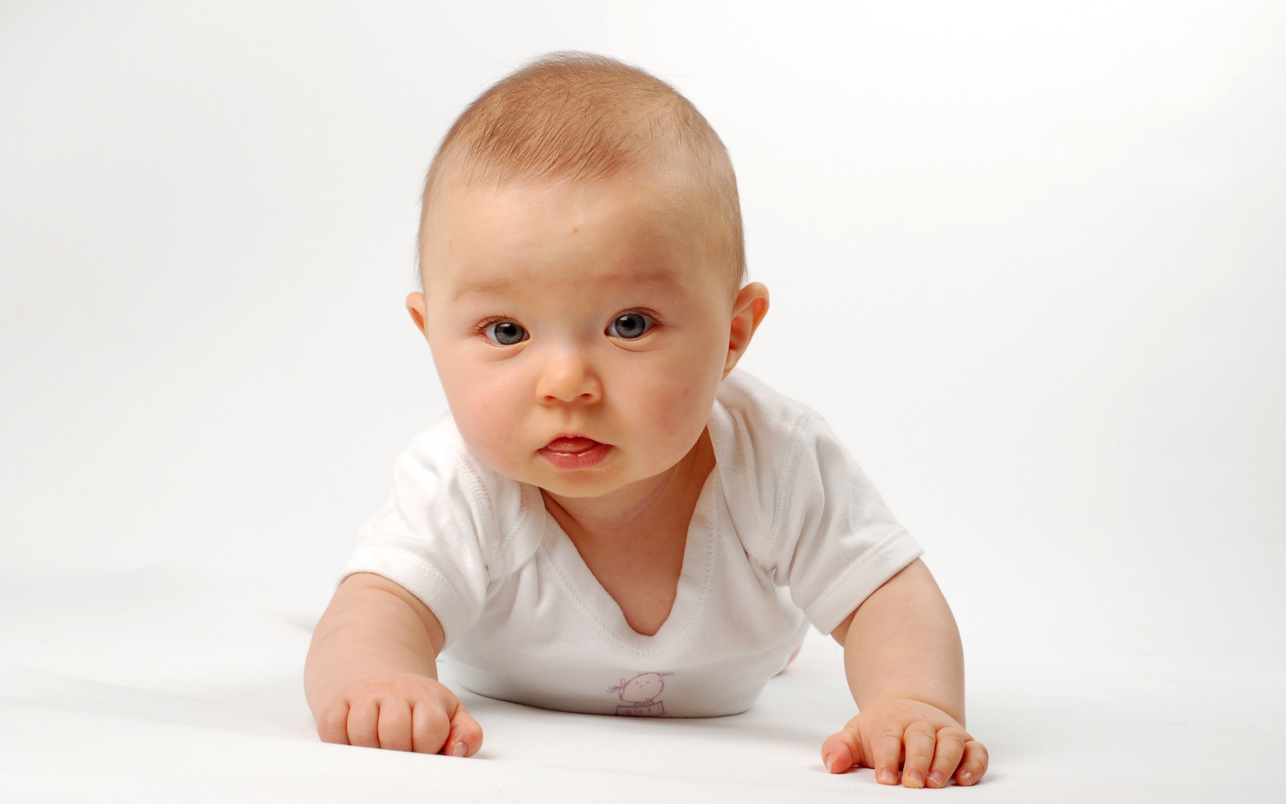 baby crawling on white surface