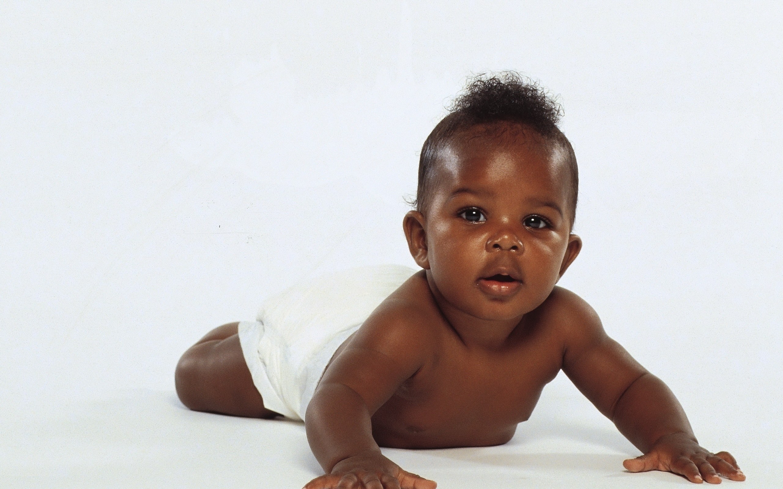 Baby crawling on white surface