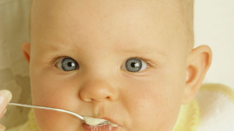 Baby Eating from Spoon — Beige