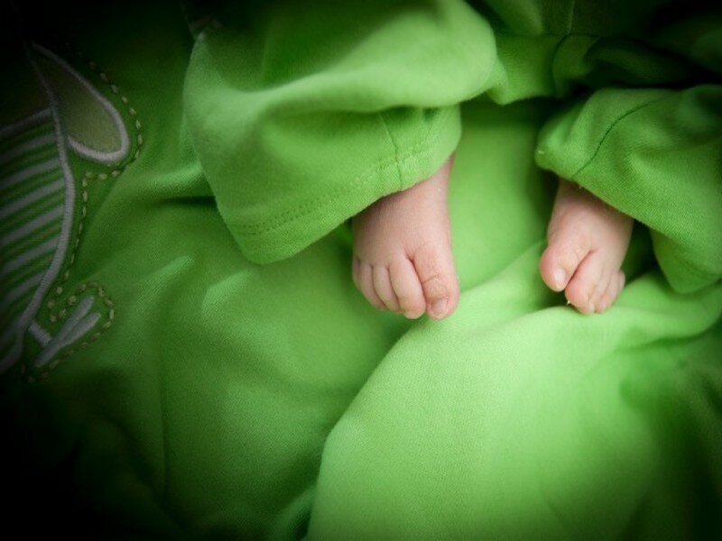 Baby feet in green blanket