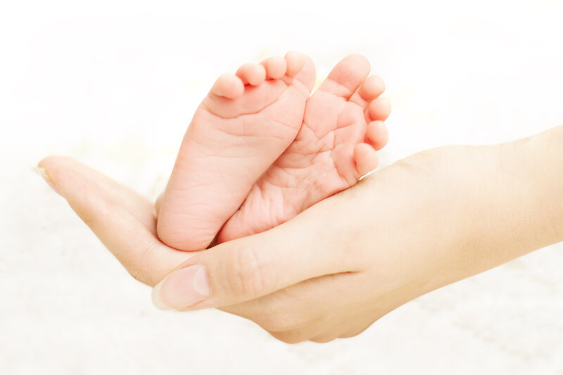 Baby Feet in Hands — White, Serene