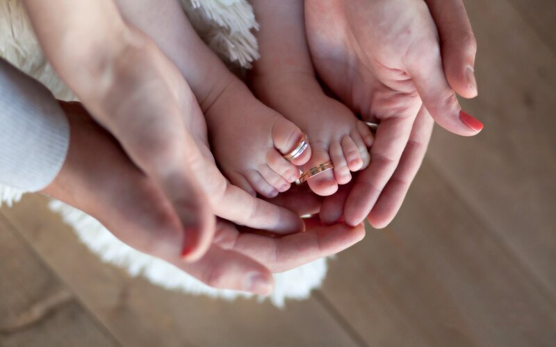 Baby Feet in Hands — White, Tender