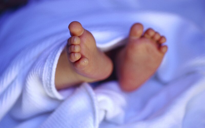 Baby feet under blanket