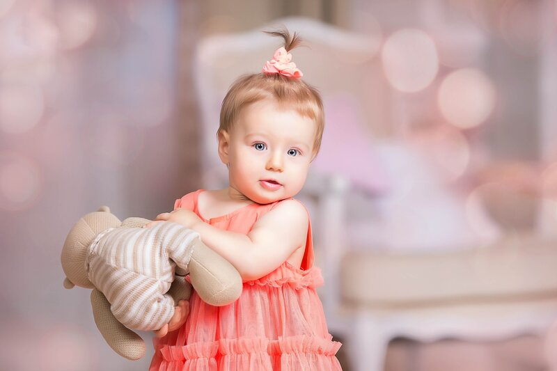 Baby Girl Holding Teddy Bear