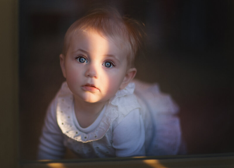 Baby Girl Looking Through Window