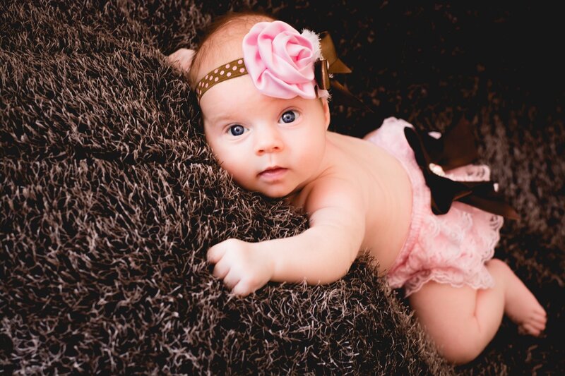 Baby Girl Lying Down — Brown, Calm