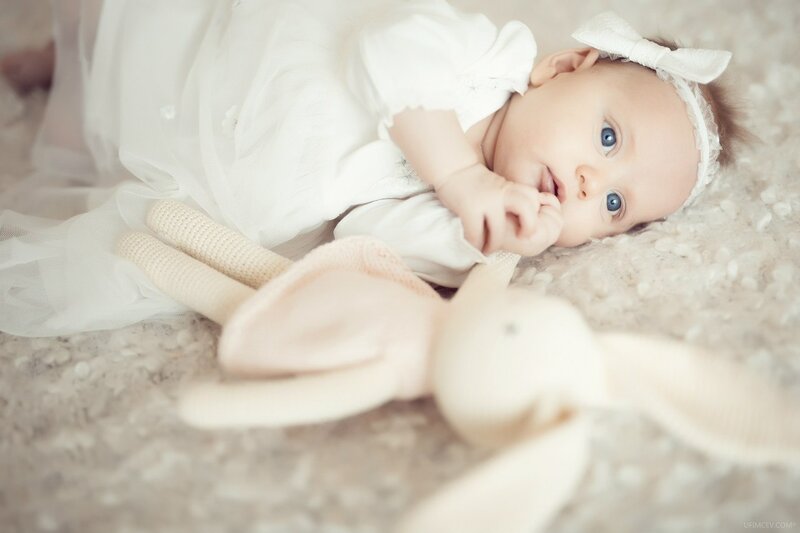 Baby Girl Lying Down — White, Serene