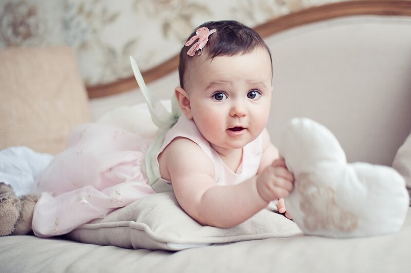 Baby Girl Lying on Bed