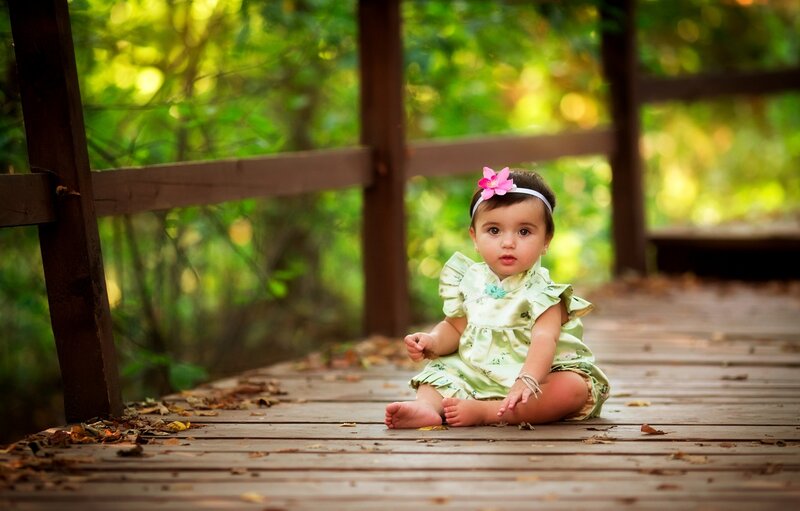 Baby Girl Sitting on Bridge