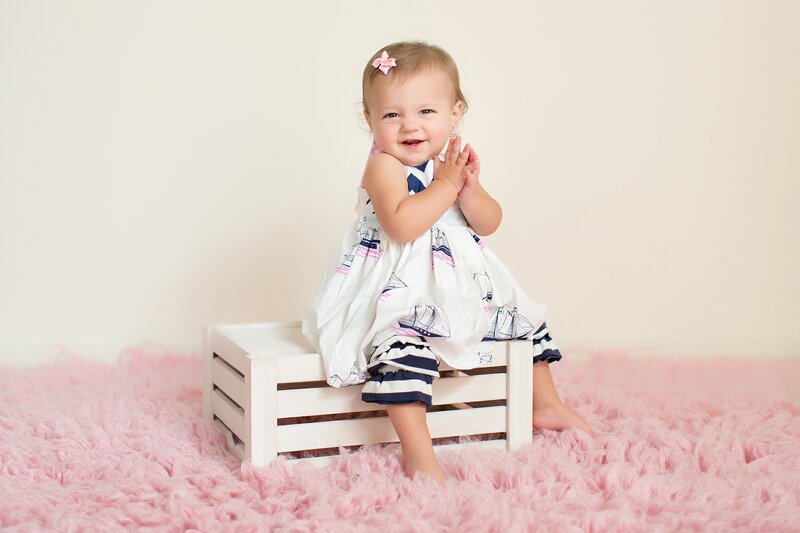 Baby Girl Sitting on Crate