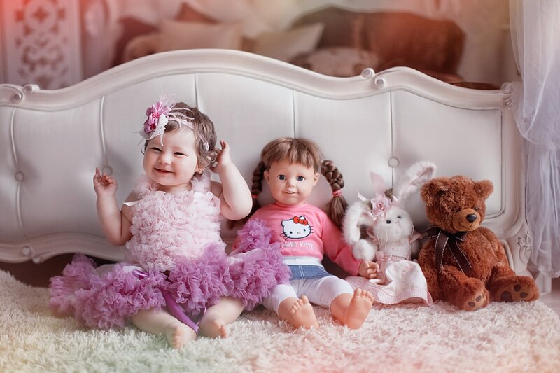 Baby Girl with Dolls