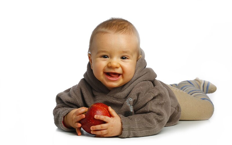 Baby holding a red apple