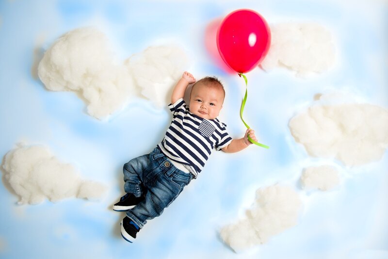 Baby Holding Balloon