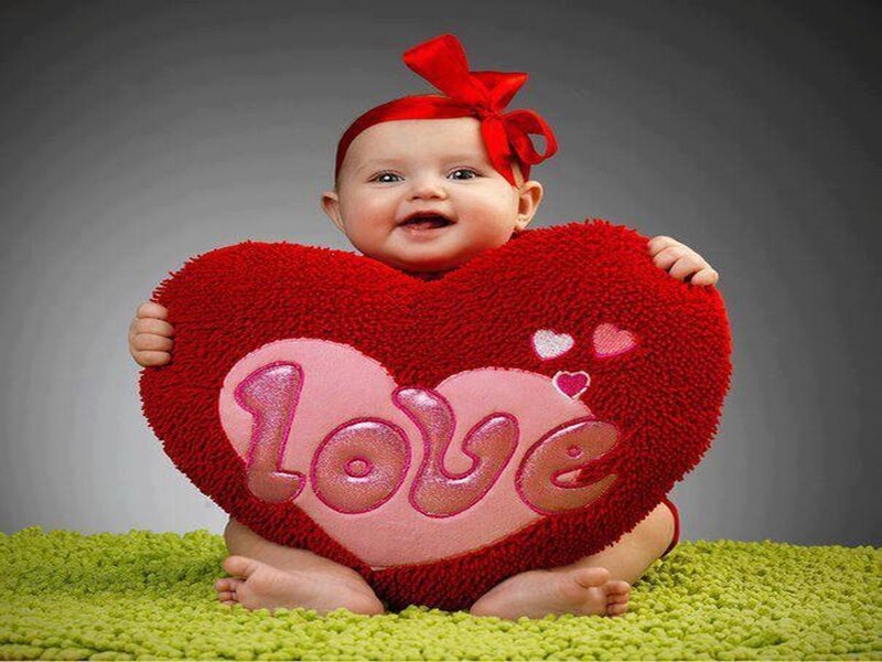 Baby Holding Heart Pillow