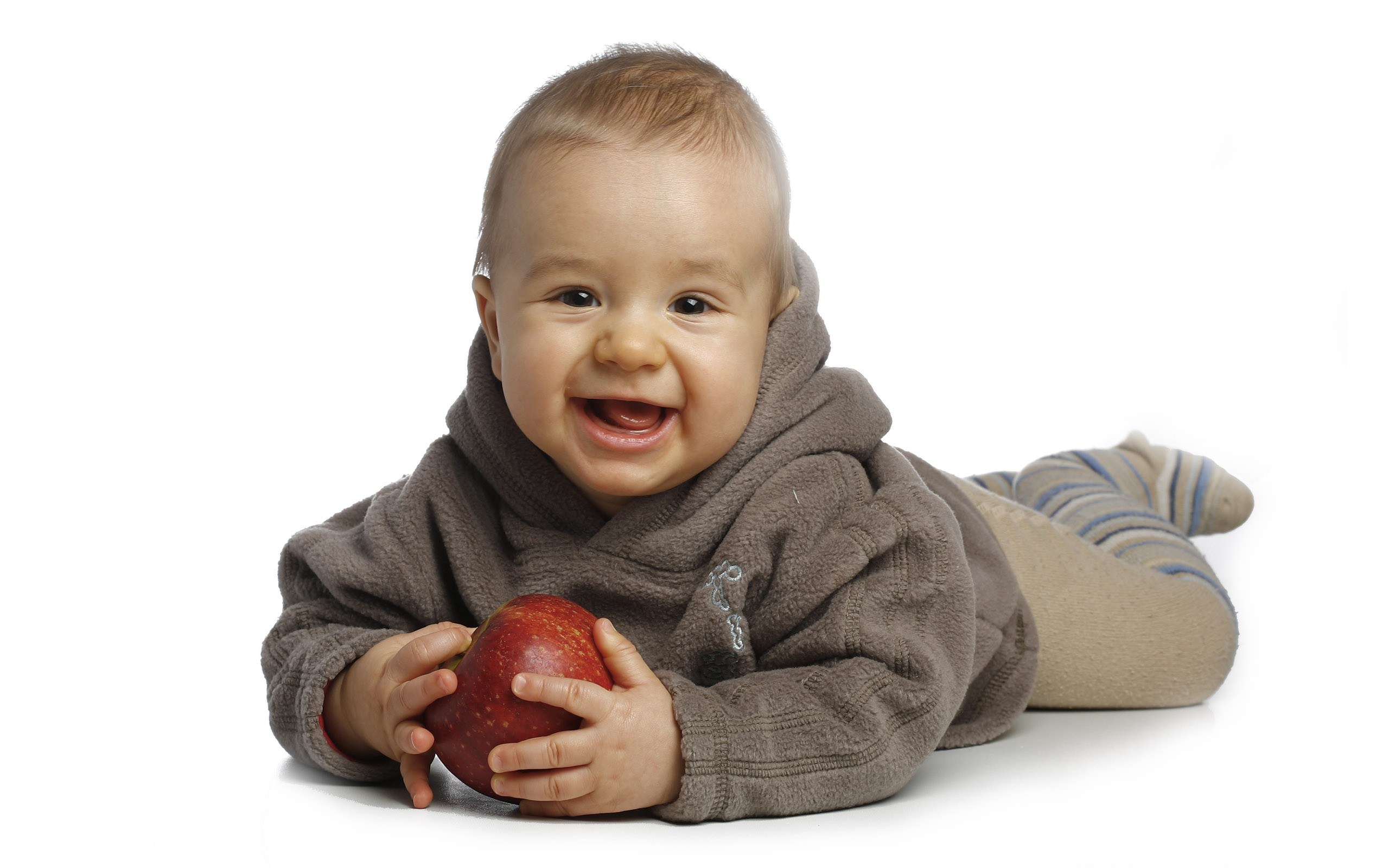 Baby holding red apple